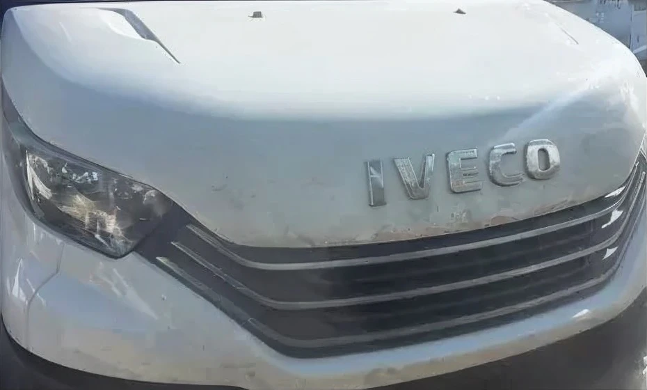 Scène nocturne avec véhicule automobile en mouvement, phares allumés créant un effet de vitesse par flou directionnel. Environnement extérieur sombre avec traînées lumineuses colorées.